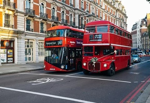 two red buses in a london street