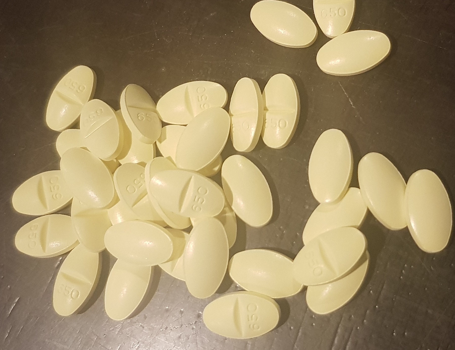 a pile of yellow tablets.